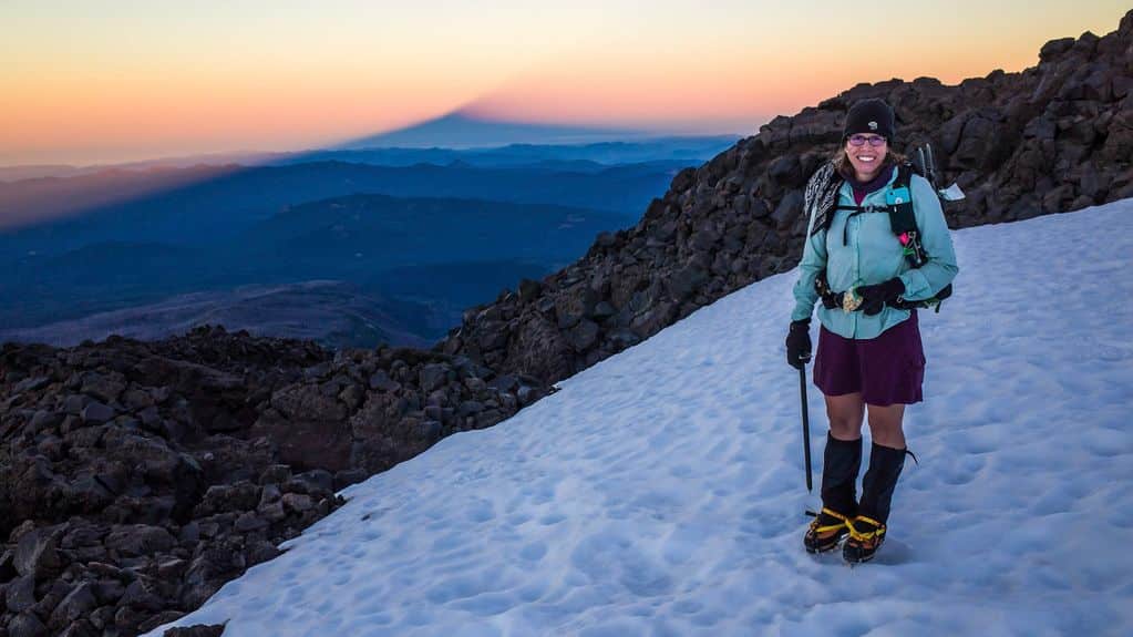 Aaron Owens Mayhew the Backcountry Foodie hiking at high altitude eating a nutritious snack.