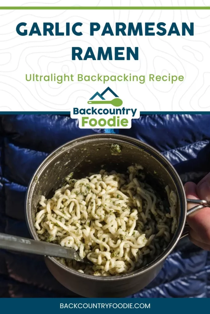 Vertical Pinterest graphic for Garlic Parmesan Ramen ultralight backpacking recipe, featuring a bowl of ramen on a down jacket background and Backcountry Foodie branding.