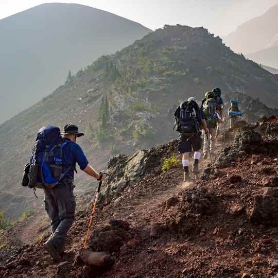 backpackers carrying heavy backpacks while hiking over difficult terrain while fueling with the ketogenic diet