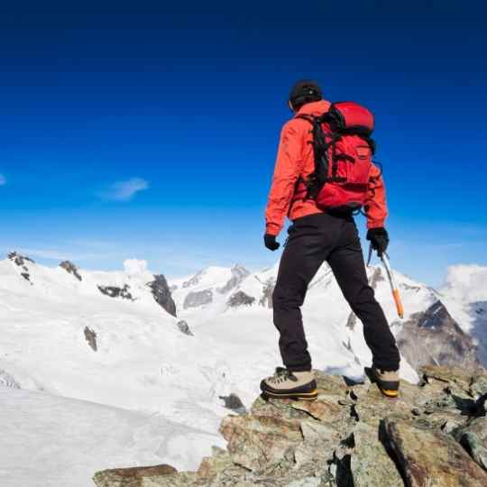 backpacker with ice axe hiking at high altitude on the keto diet