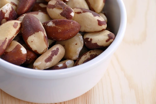 brazil nuts in white bowl