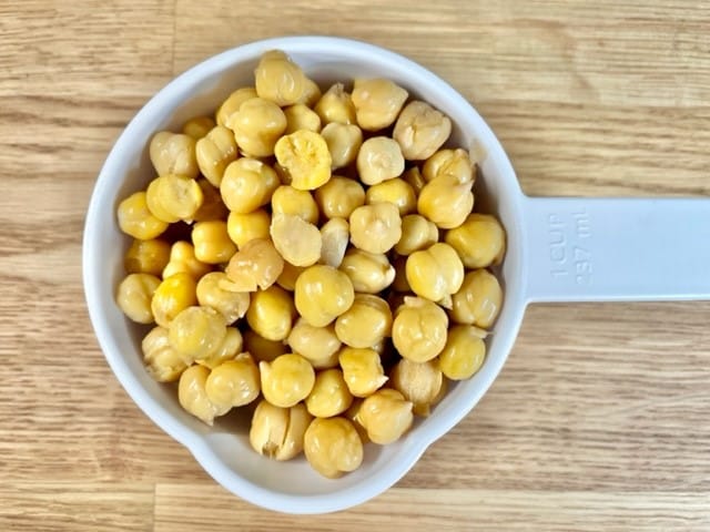 Canned chickpeas before dehydrating in a one cup measuring cup.