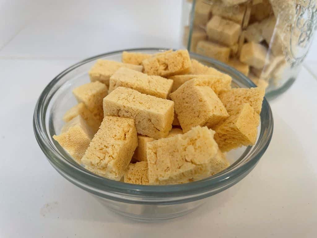 Freeze dried tofu in a glass bowl ready to be used in backpacking meals.