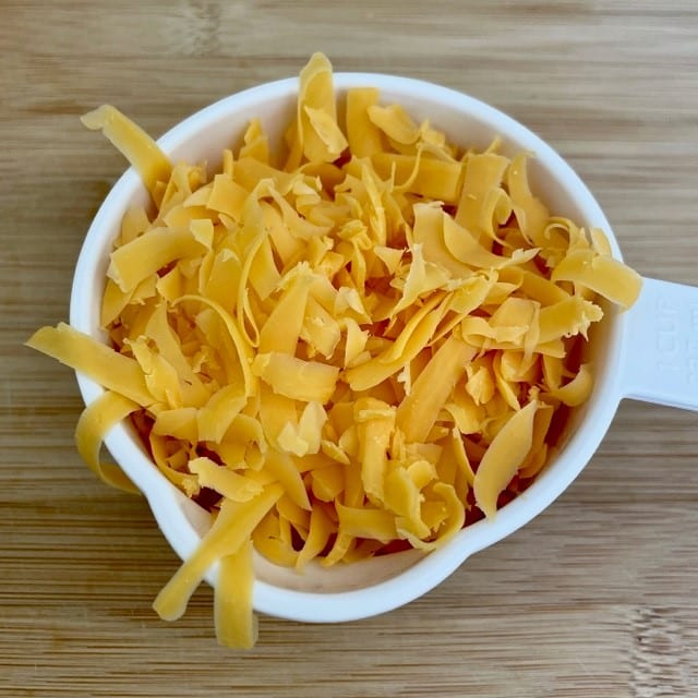If you love cheese but can't stand the thought of going without it on your next backpacking trip, never fear! With a minimal effort, you can dry your own cheese at home. Doing so not only lightens your load but makes DIY backpacking meals taste that much better! #hikingfoodideas #diybackpackingfood #besthikingfood #howtofreezedry #backcountryfoodie