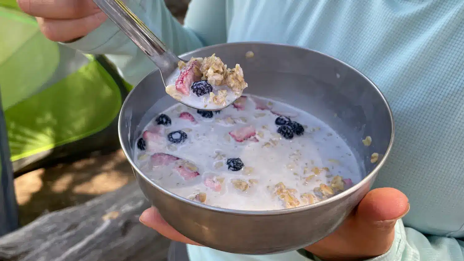 granola with milk berries hiker holding bowl thumbnail image