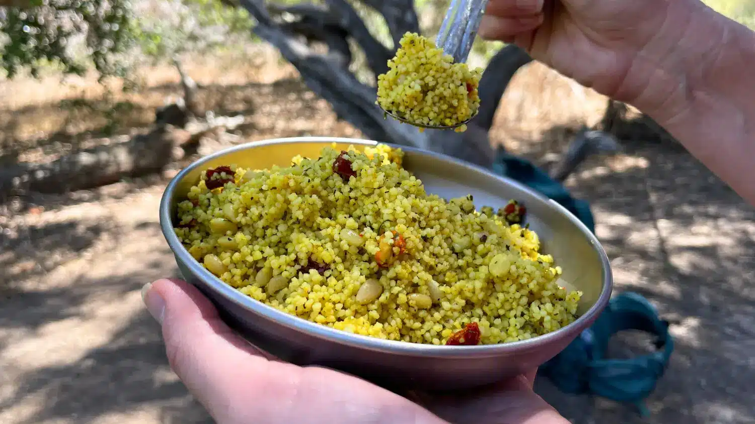 sun dried tomato couscous hiker holding plate spoon thumbnail image