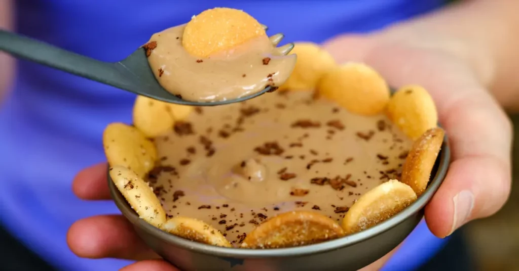 Cold soak tiramisu backpacking dessert topped with cookie wafers and chocolate shavings in a trail bowl