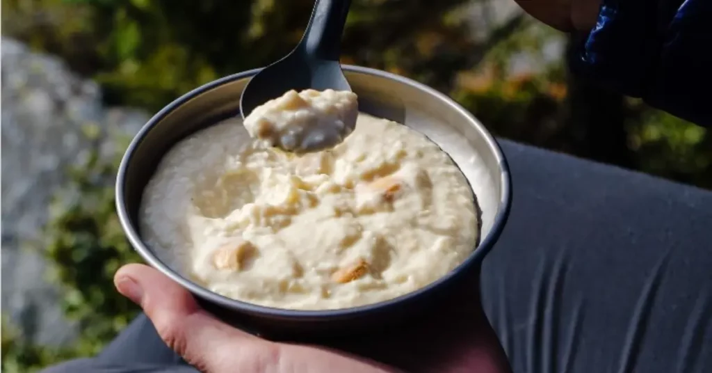white chocolate pudding hiker holding plate with spoon thumbnail image